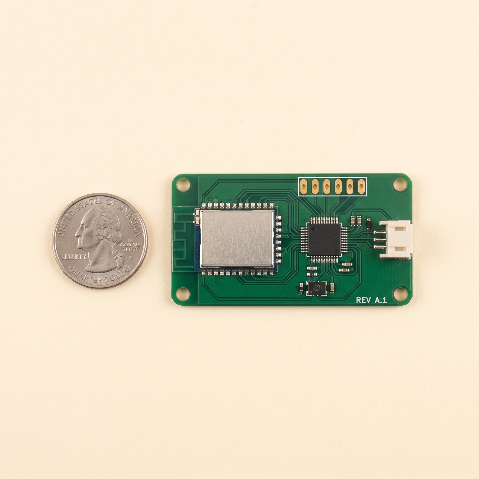Bare green acquisition PCB, about 65 by 35 mm, beside a US quarter
